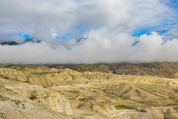 Foggy Himalayan Mountain and Desert of Upper Mustang in Nepal as seen from Lho La Pass