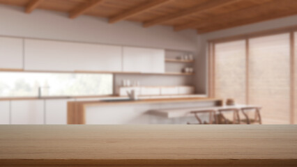 Empty wooden table, desk or shelf with blurred view of minimal white kitchen with island and dining chair, cabinets and wooden ceiling, modern interior design concept