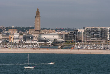 Le Havre, Northern France.  12 June 2023.  The beach area and the tall tower of Saint Josephs Roman...