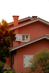 Verona, Italy - 04 19 2023: Italian-style facade of the private house. Neat and tidy house. Ancient shutters on the windows. House with stylish shutters. 