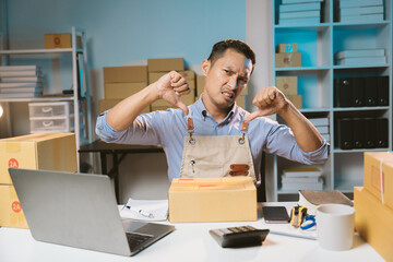 Asian male small business owner using mobile app on smartphone checking parcel box. Warehouse...
