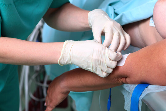 Anesthesiologist installs central venous catheter to patient before surgery.Preparation for operation. Installation of an intravenous catheter.