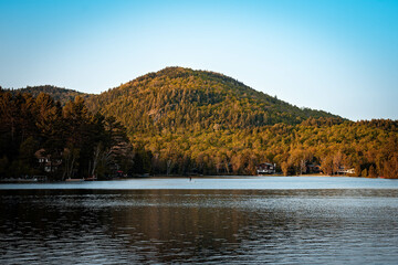 sunset in the mountains in a town lake with blue 