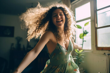 Young woman expressing freedom and vitality as she dances alone at home, a genuine celebration of emotion and personal lifestyle.
