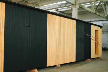 Fototapeta premium Newly built single storey prefabricated modular building. Prefabricated mobile wooden house at construction site