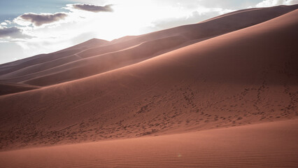 desert with cloudy sky during sunset