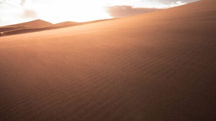 desert with cloudy sky during sunset