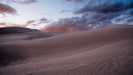 desert with cloudy sky during sunset