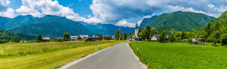 A panorama view towards the alpine village of Stara Fuzina above lake Bohinj in Slovenia in summertime