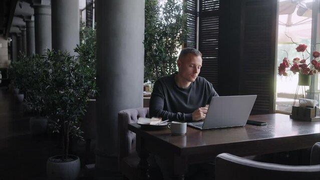 Remote Work And Online Business, Portrait Of Concentrated Successful Businessman With Laptop in Cafe