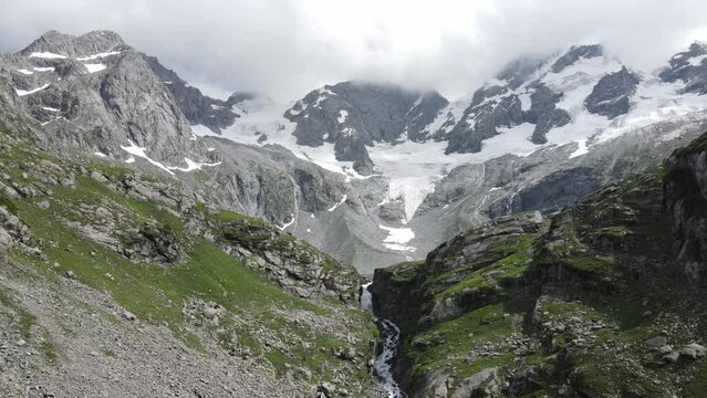 Drone descending before Katora Lake and its waterfall. Located in the KPK province of Pakistan. 