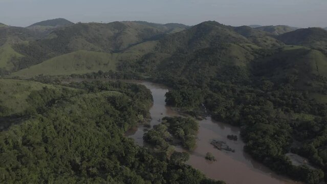 Sunset over the Para&iacute;ba do Sul river, with its brown waters and woodland on the banks. The river is the main source of water supply for the state of Rio de Janeiro.