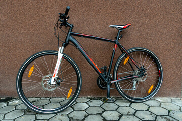 Details of a mountain bike close-up. Cycling for fun and health. Active leisure. A new bike is standing outside on a sunny summer day.