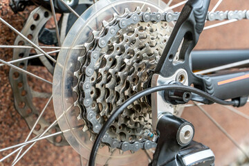 Details of a mountain bike close-up. Cycling for fun and health. Active leisure. A new bike is standing outside on a sunny summer day.