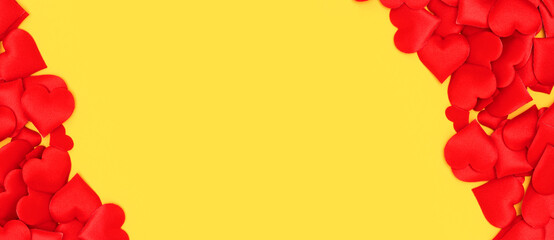 Banner with frame made of red hearts confetti on a yellow background.