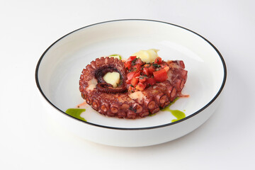 Grilled octopus with potatoes. Mashed potatoes with cream. White background.Copy space. Isolated object.
