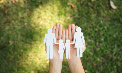 Background of paper family icon held in hand symbolize dedication to environmental friendly...