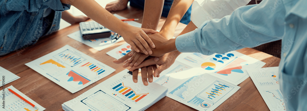 Leinwandbilder analyst team putting hand together after successfully analyzed financial dashboard papers for busine