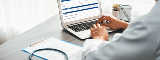 Doctor carefully review detailed medical report on laptop and diagnosing illness for effective...