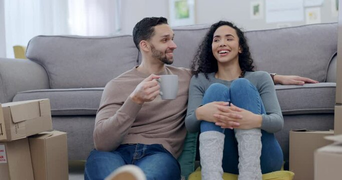 Couple, coffee and new house on floor, talk or relax together in lounge for thinking, idea or fresh start. Man, woman and moving with tea cup, boxes or cardboard package with chat in home living room