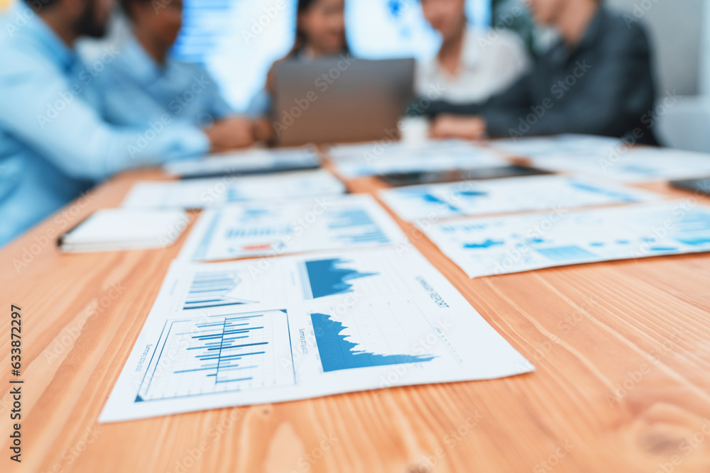 Poster focus financial dashboard paper showing graphs and chart with blurred background of diverse business