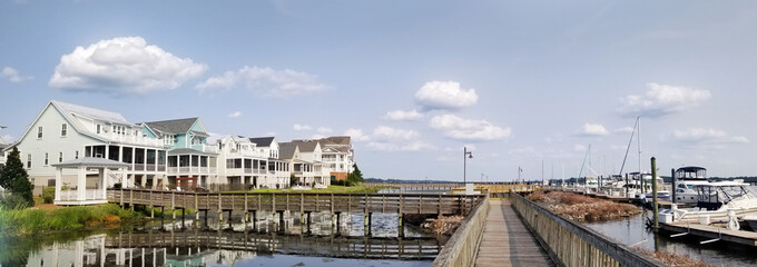 Panoramic view of riverfront homes and boats along the boardwalk in Washington NC