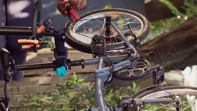 Vertical video Focused young black woman preparing necessary expert work tools for repairing broken bicycle parts. Sports-loving female aranging different professional equipment for servicing damaged
