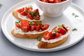 Tomato basil and cream cheese bruschettas with fresh cherry tomatoes