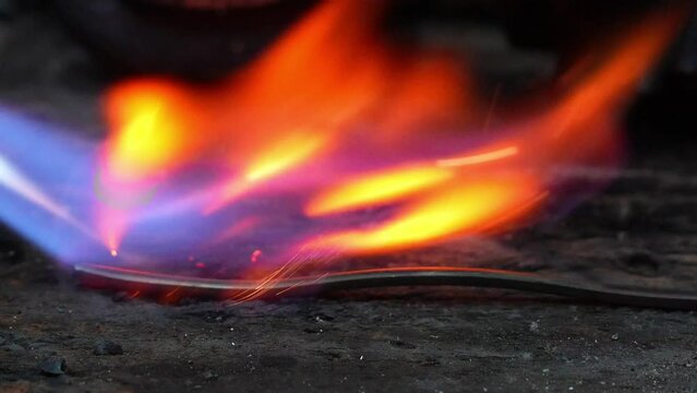 goldsmith jeweler use torch to heat gold metal ring making process