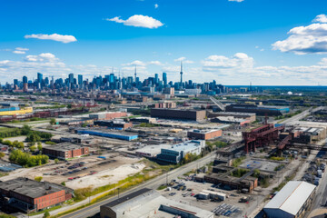 Fototapeta premium Vibrant Cityscape of the Expansive Industrial Area as Seen from Above, Showcasing Skyscrapers, Warehouses, and Busy Streets