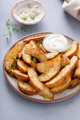 Baked potato wedges with herbs and parmesan served with a dipping sauce