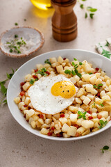 Potato hash with pancetta topped with a fried egg