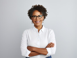 Portrait of a Smiling African American Business Woman middle age 50s 40s arms crossed isolated white background