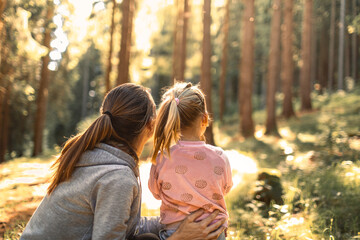 parent and child mother daughter enjoying time together bonding in nature forest 