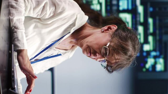 Vertical video Capable repairman in cloud computing business equipped to handle complex computational operations, doing regular upgrades to supercomputers, increasing processing power to prevent