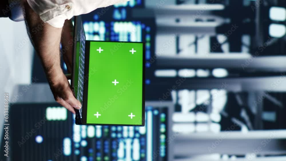Poster vertical video knowledgeable it professional navigating network of server racks in industrial hub. r