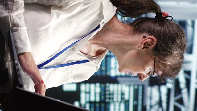 Vertical video Proficient system administrator looking around revolutionary data center, preparing to start comission on damaged high tech server rackmounts in order to ensure ideal operations