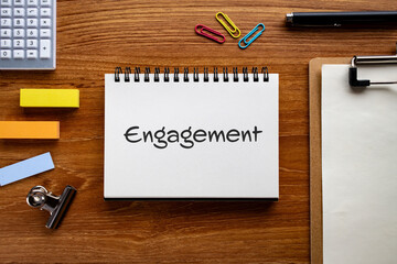 There is notebook with the word Engagement. It is as an eye-catching image.