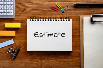 There is notebook with the word Estimate. It is as an eye-catching image.