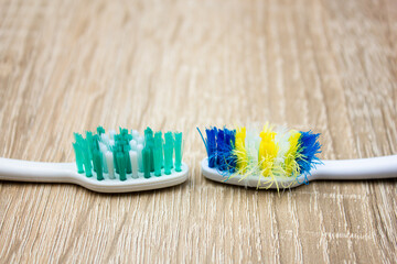 Old and new toothbrush. Used and new toothbrush comparison. Toothbrush with frayed bristles.
