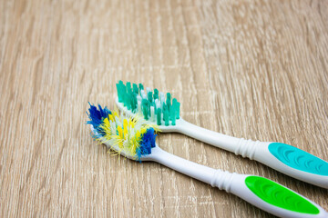 Old and new toothbrush. Used and new toothbrush comparison. Toothbrush with frayed bristles.