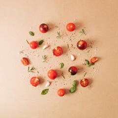 Naklejka na ściany i meble Creative arrangement of cherry tomatoes, basil, rosemary, garlic, wild oregano. Minimal food concept. Flat lay