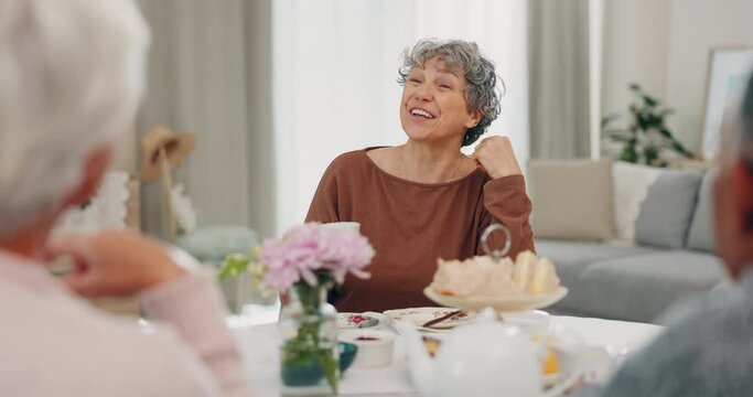 Tea, funny and senior woman with friends in home living room, bonding and talking at table. Happy people, elderly person and laughing at comedy, story and smile for conversation, gossip and coffee