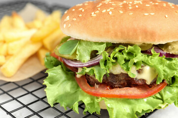 Delicious burger with beef patty and lettuce on white table, closeup