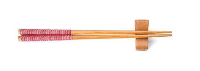 Pair of wooden chopsticks with rest isolated on white, top view