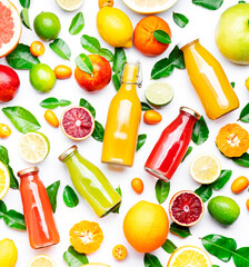 Citrus fruit juice bottles, food background. Summer drinks and beverages. Mix of different whole...