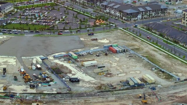 Beginning of construction works on prepared ground. Large building site with scattered equipment in american rural area. Development of residential housing in US suburbs. Real estate market in USA
