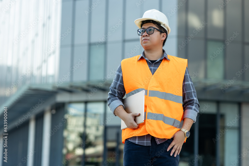Poster construction engineer standing at construction building site with ipad for checking work constructio