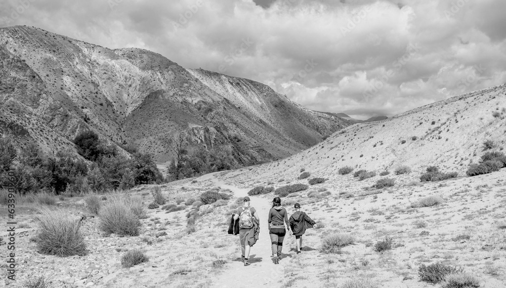 Sticker People walking in the countryside. Black and white toned image 