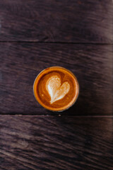 Beautiful cappuccino in a glass mug on a wooden background. Stylish concept for advertising flat lay coffee